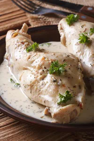 Rabbit meat stewed in sour cream close-up on a plate. vertical — Stock Photo, Image