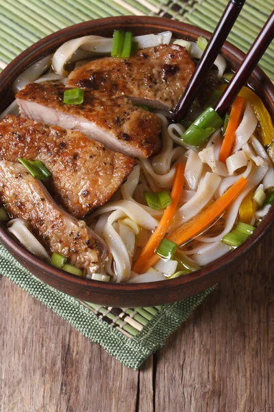 Asian soup with duck and rice noodle and chopsticks. top view — Stock Image Asian soup with duck and rice noodle and chopsticks. top view Royalty Free Stock Photos