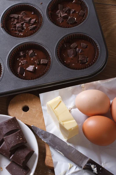 Preparation of chocolate muffins closeup top view vertical — Stock Photo, Image