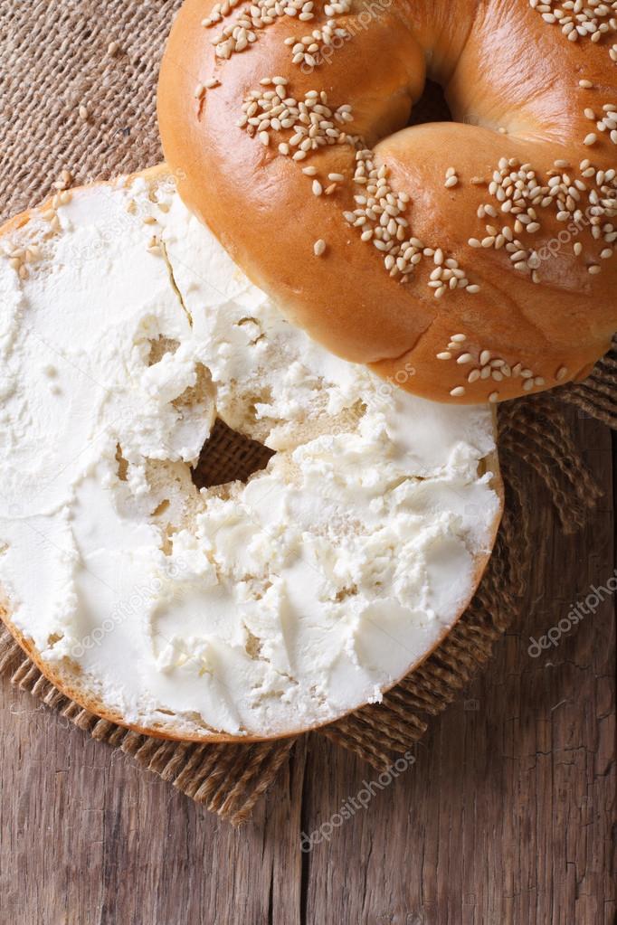 Bagel with cream cheese and sesame  vertical top view