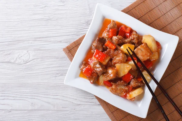 Asian pork with pineapple in sweet and sour sauce. top view
