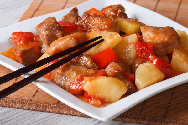 pork meat with pineapple and vegetables in sweet and sour sauce
