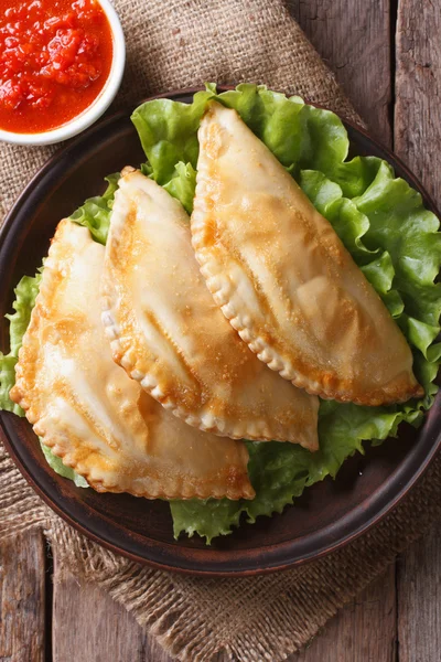 Traditional empanadas and sauce closeup. vertical top view — Stock Photo, Image