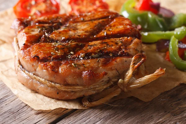 Delicious medallion of pork close-up on an old table. horizontal — Stock Photo, Image