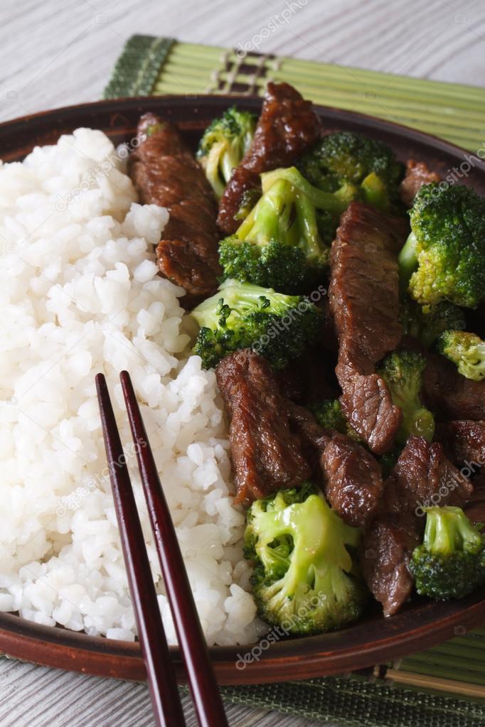 Asian beef with broccoli and rice close-up. Vertical