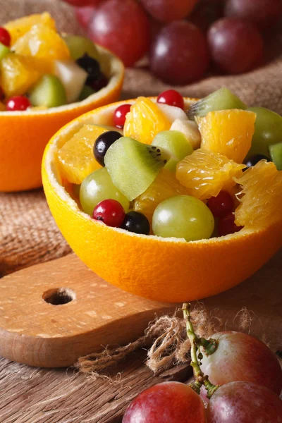 Oranges stuffed with fresh fruit salad close-up vertical — Stock Photo, Image