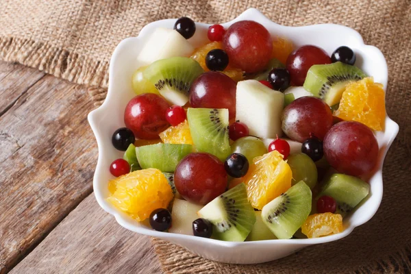 Fruit salad of oranges, grapes. pears, kiwis closeup. Horizontal — Stock Photo, Image