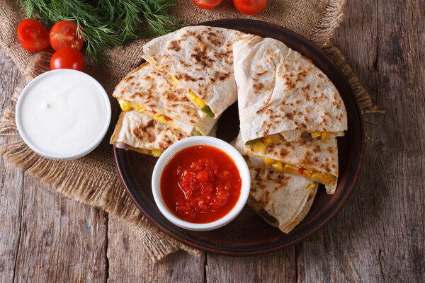 Quesadilla with vegetables and sauces. horizontal top view