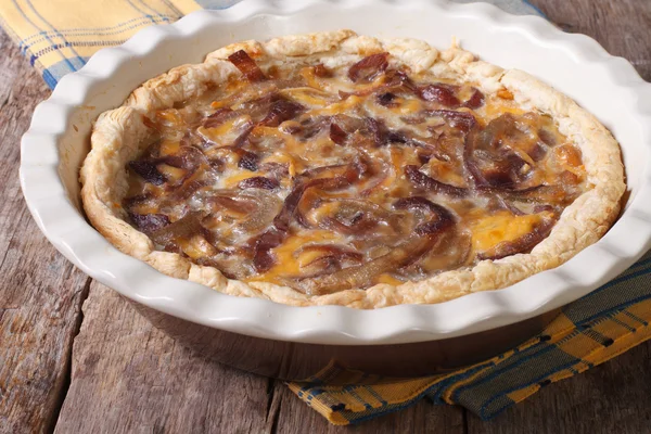 Onion pie with cheese and cream in baking dish close-up — Stock Photo, Image