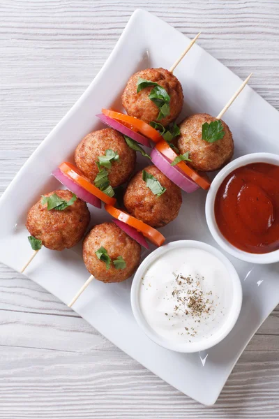 Meatballs on skewers and sauces vertical top view — Stock Photo, Image