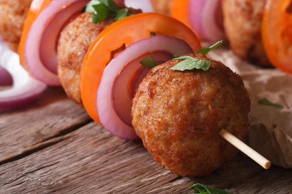 Roasted meatballs on skewers  an old table close-up, horizontal — Stock Photo, Image