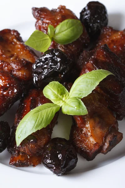 Pork ribs stewed with prunes and basil. vertical close-up. — Stock Photo, Image