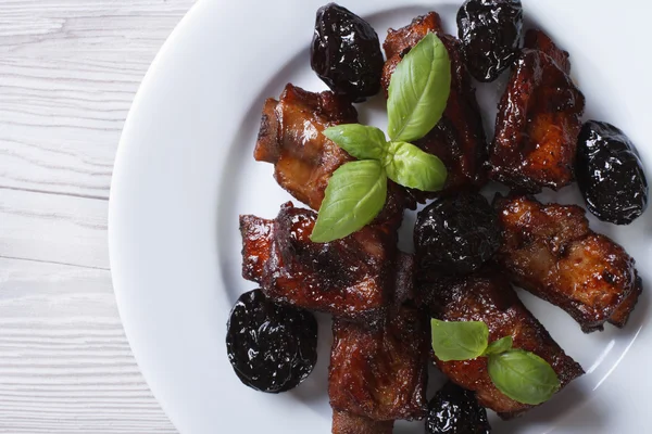 Pork ribs stewed with prunes closeup. horizontal top view — Stock Image Pork ribs stewed with prunes closeup. horizontal top view Stock Photo