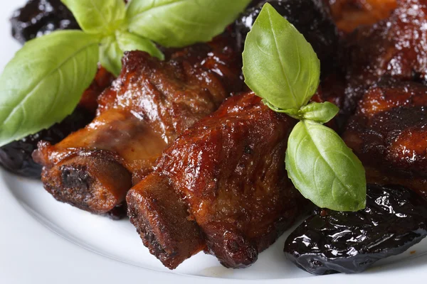 Pork ribs stewed with prunes macro. horizontal top view — Stock Image Pork ribs stewed with prunes macro. horizontal top view Royalty Free Stock Photos