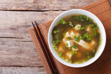 Japanese miso soup in a white bowl horizontal top view clipart