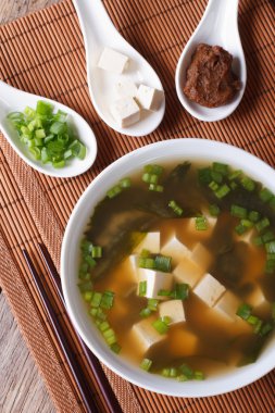 Miso çorbası görünümü'nde beyaz kase ve malzemeler dikey üst