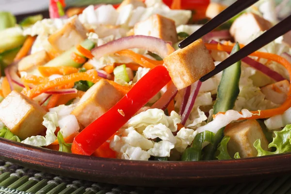 Healthy salad tofu and vegetables with chopsticks macro — Stock Photo, Image