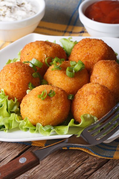 potato croquettes on a white plate close-up. vertical