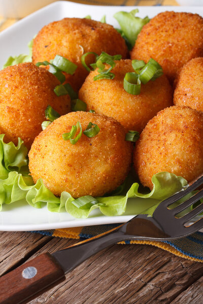 potato croquettes and vegetables close-up. Vertical