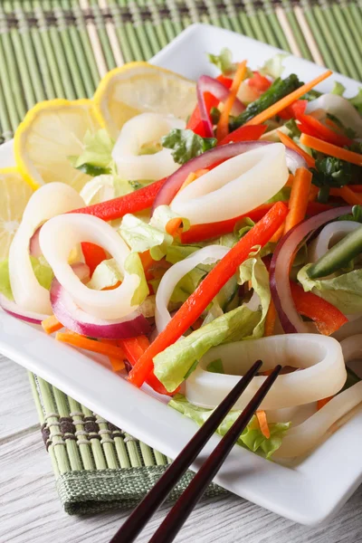 Salad with vegetables and squid vertical top view closeup — Stock Photo, Image