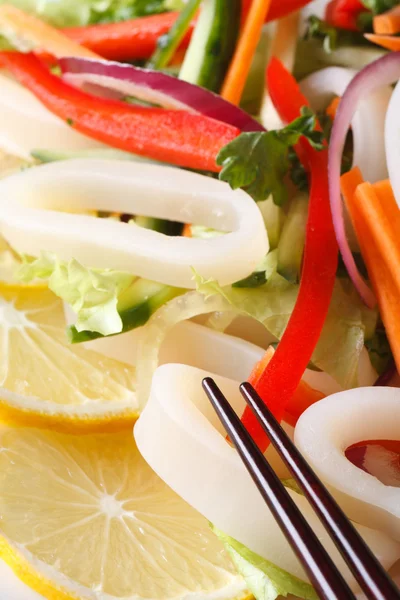 Japanese salad with vegetables and squid macro. Vertical — Stock Photo, Image