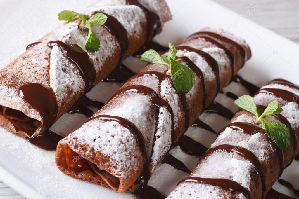 chocolate crepes with sauce and mint close up horizontal