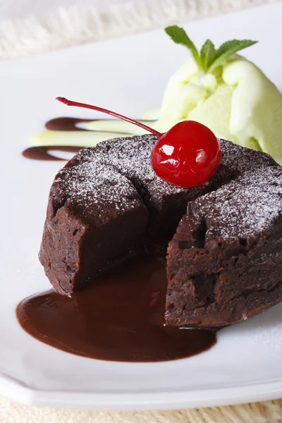 Fondant cake with cherries and mint ice cream close-up. Vertical — Stock Photo, Image