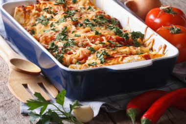 enchilada içinde pişirme çanağı closeup masanın üzerinde. Yatay