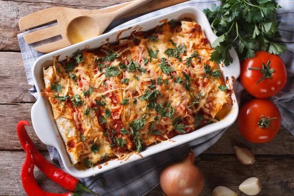 Mexican enchilada in a baking dish horizontal top view close-up — Stock Photo, Image