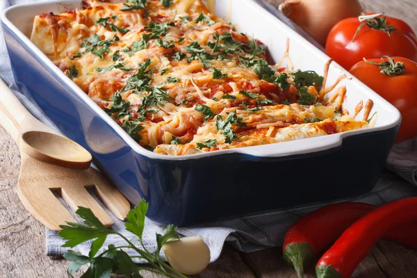 Enchilada in baking dish closeup on the table. Horizontal — Stock Image Enchilada in baking dish closeup on the table. Horizontal Royalty Free Stock Photos