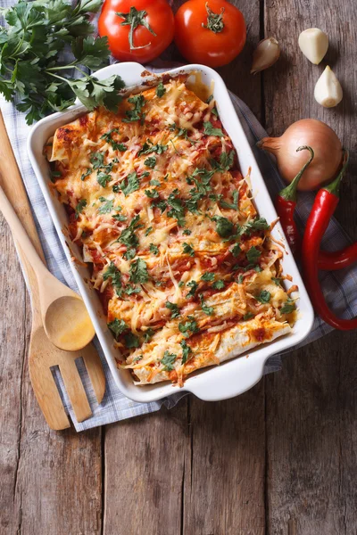 Mexican enchilada in a baking dish vertical top view — Stock Image Mexican enchilada in a baking dish vertical top view Stock Picture