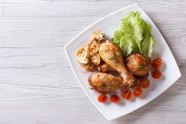 Chicken legs with mushrooms and tomatoes horizontal top view — Stock Image Chicken legs with mushrooms and tomatoes horizontal top view Royalty Free Stock Photos