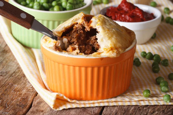 Pastel de carne australiana en una olla sobre un fondo de guisante verde —  Fotos de Stock