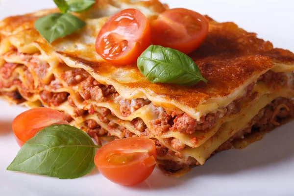Portion of Italian lasagna closeup on a white plate. Horizontal — Stock Photo, Image