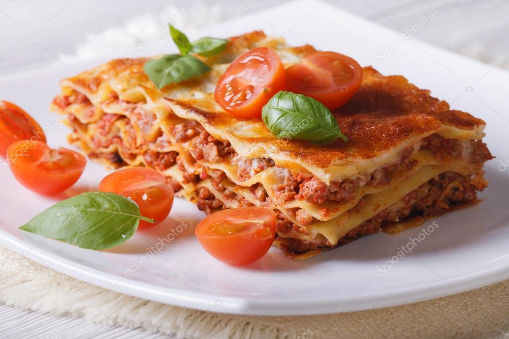Italian Lasagna with fresh basil on a plate. horizontal