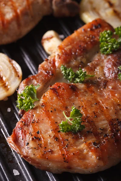 Juicy pork steak grilled in a pan grill macro vertical — Stock Photo, Image