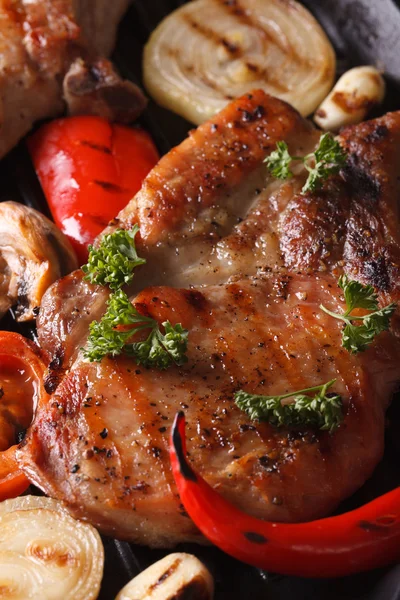 Grilled pork steak with vegetables top view macro vertical — Stock Photo, Image