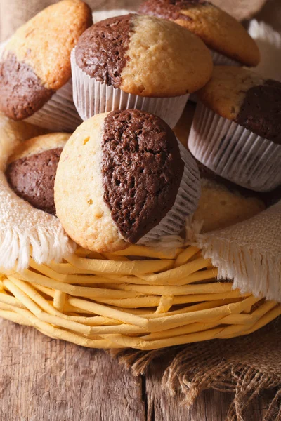 Chocolate orange muffins in a basket close-up, vertical — Stock Photo, Image