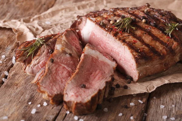 Carne cortada médio bife em uma mesa velha. close-up horizontal — Fotografia de Stock