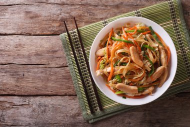 Chow Mein: fried noodles with chicken, horizontal top view clipart