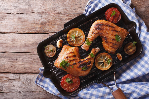 chicken leg and vegetables on the grill pan. horizontal top view