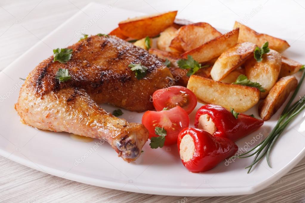 Grilled chicken leg, roasted potatoes and vegetables, horizontal