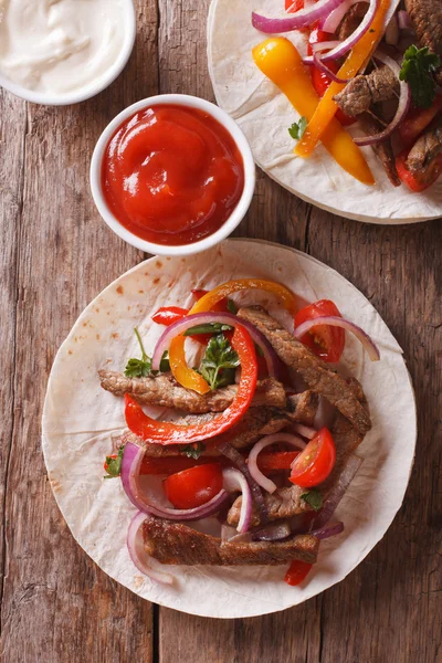 Delicious tortillas with meat and vegetables vertical top view — Stock Photo, Image