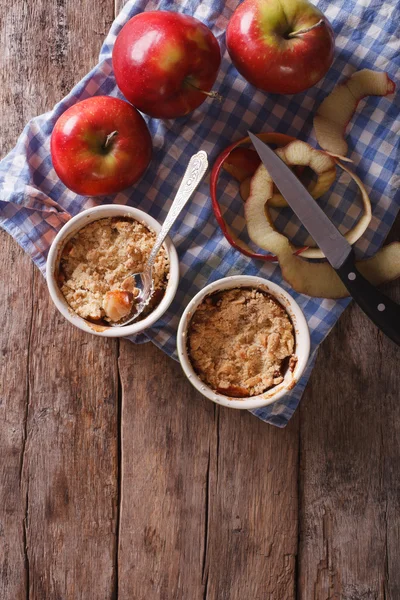 apple crumble in portion pots on the table. vertical top view