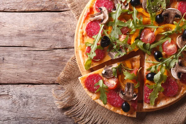 Pizza with herbs, salami and vegetables horizontal top view — Stock Photo, Image