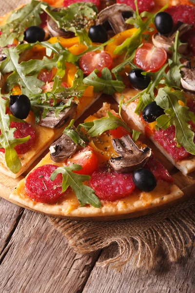 Pizza with rucola, salami and olives vertical top view — Stock Photo, Image