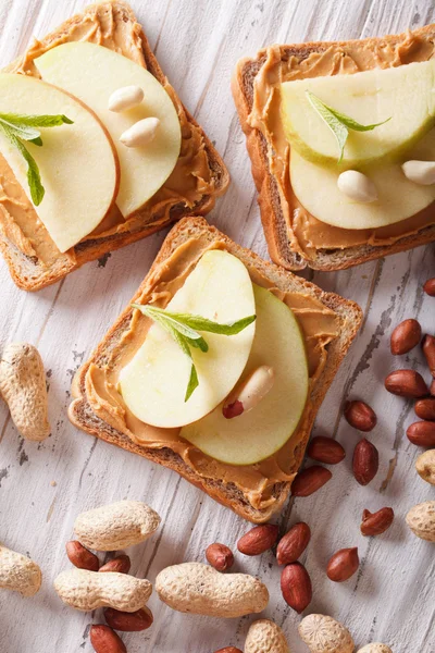 sweet toast with apple and peanut butter vertical top view