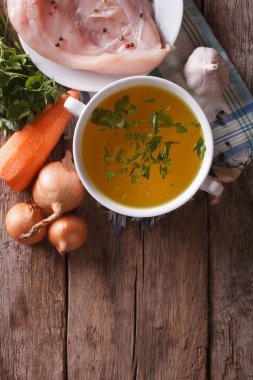 Chicken broth and ingredients. vertical top view, homemade clipart