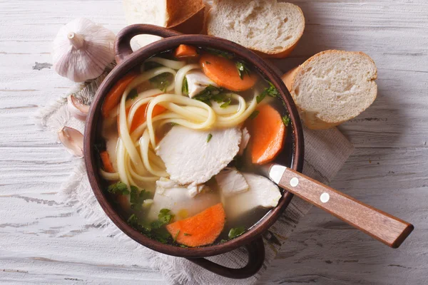 Rustic chicken soup with noodles closeup. Horizontal top view — Stock Photo, Image