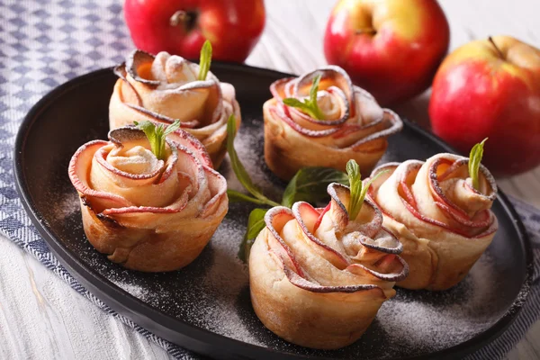 Cakes rose out of an apple close-up on a plate — Stock Photo, Image
